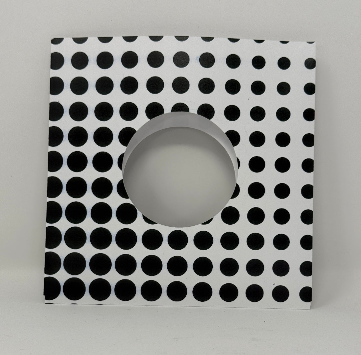 7" record sleeve in card stock with graduating polka dots in an op art pattern