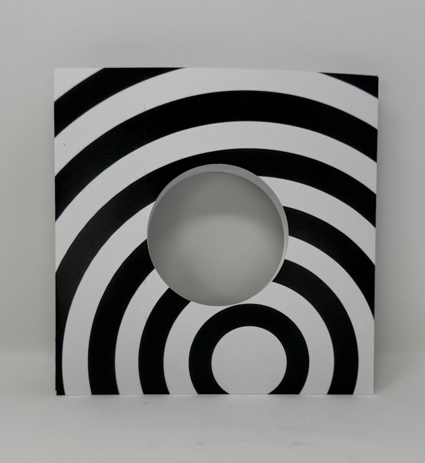 7" Record sleeve in heavy cardstock in black and white radiating circle  op art pattern