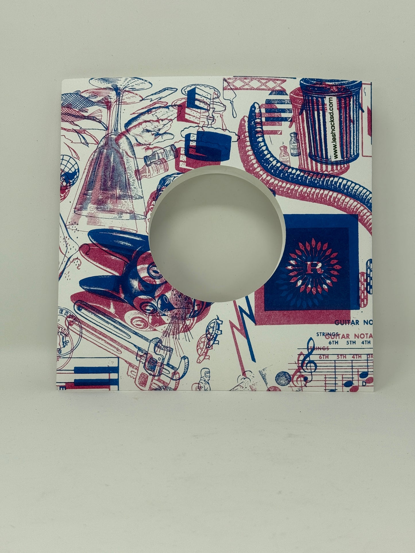 7" cardstock record sleeve in the Zazzo print in navy and pink. 
