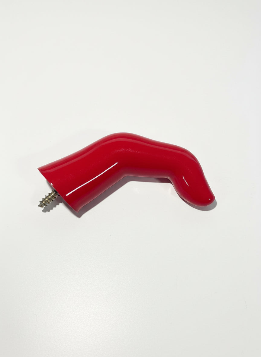 Red Finger shaped wall hook on flat white surface