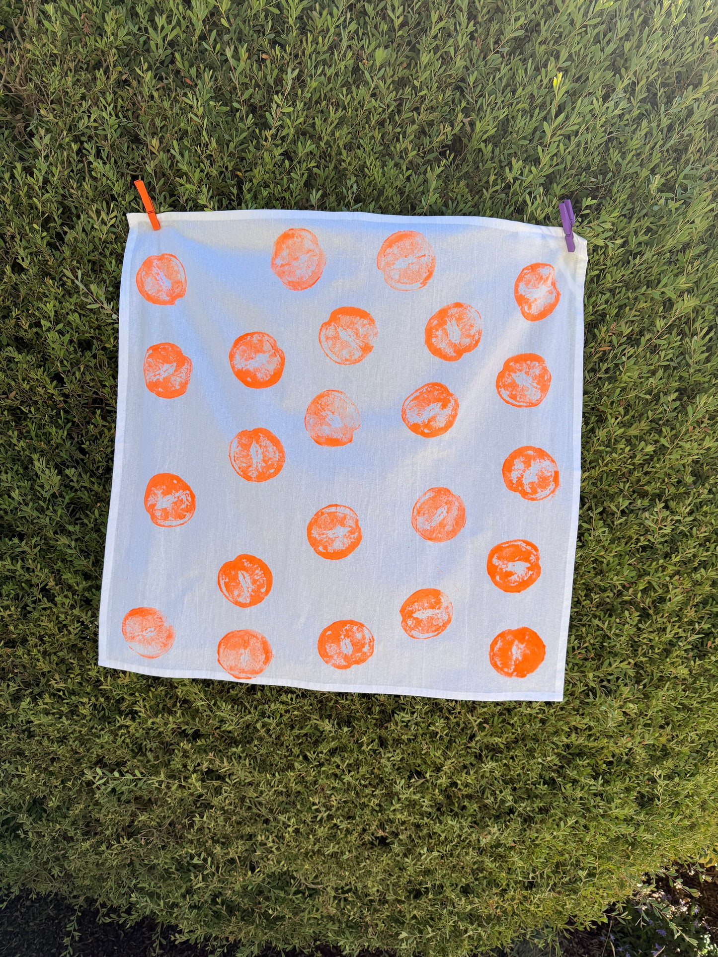 handprinted cotton dish towel with neon orange orange print