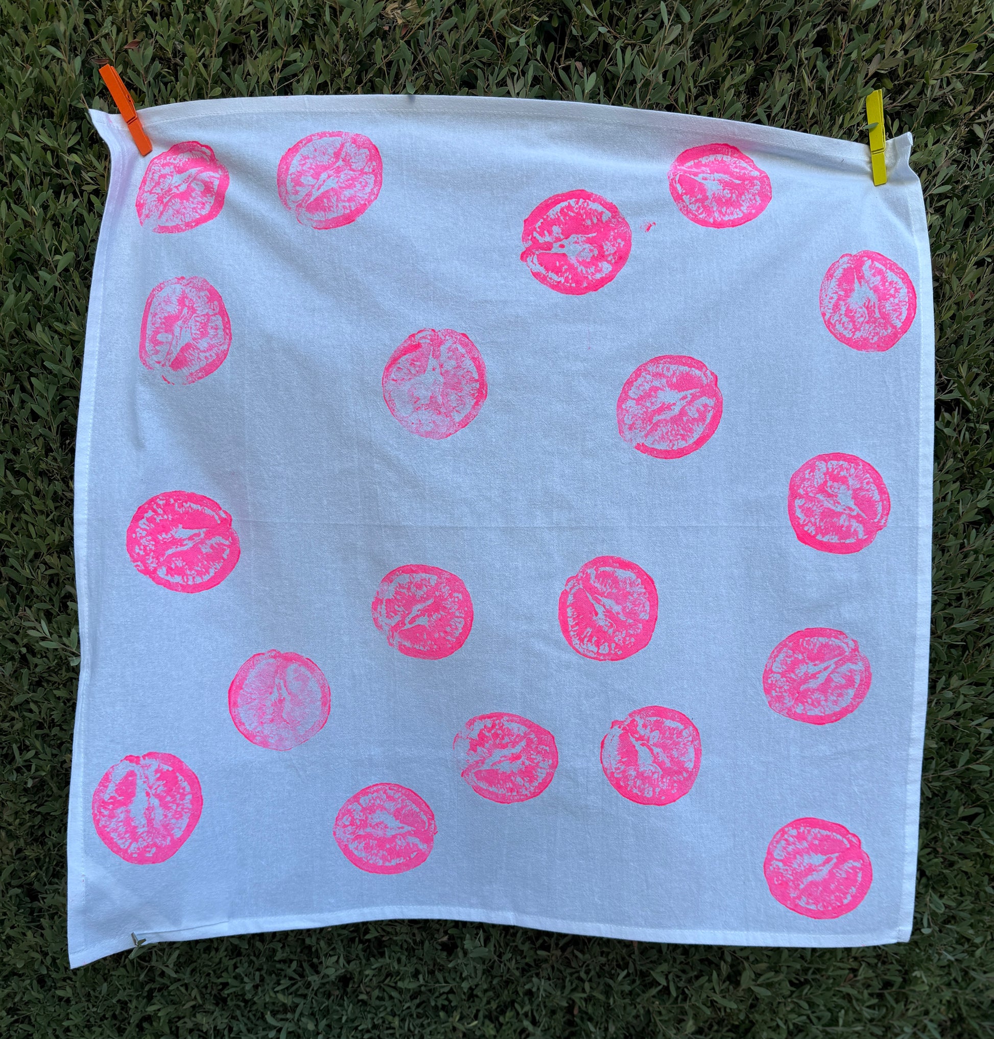handprinted cotton dish towel with neon pink orange print